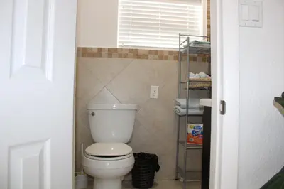 a bathroom with a white toilet in a room at Master King Suite by Hard rock stadium and casino in Miami