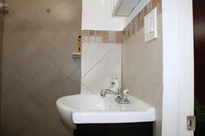 a bathroom with a white sink in a room at Master King Suite by Hard rock stadium and casino in Miami