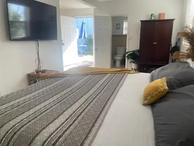 a bedroom with a bed with a television on the wall at Master King Suite by Hard rock stadium and casino in Miami