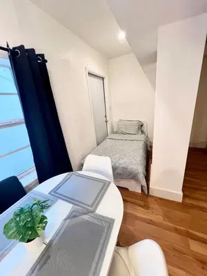 a room with a bed and a table with a window at South Beach Paradise: best of Miami in Miami Beach