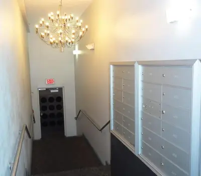 a hallway with a chandelier and a room with a staircase at South Beach Paradise: best of Miami in Miami Beach