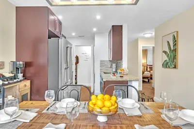 a kitchen with a table with a bowl of oranges on it at Estelo's Place - Modern townhouse with King bed, only 5 min from the Airport! in Miami