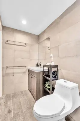 a bathroom with a toilet and a sink at Estelo's Place - Modern townhouse with King bed, only 5 min from the Airport! in Miami