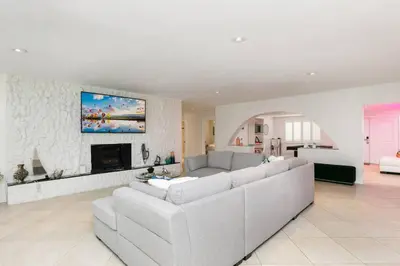 a living room with a couch and a fireplace at ~Villa Victoria Luxury! (Pool)~1 mile from beach in Fort Lauderdale