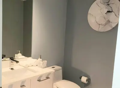 a bathroom with a sink and a toilet and a mirror at Gorgeous Upscale Condo in the Middle of Brickell in Miami