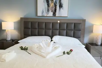a bed with two swans made out of towels at Gorgeous Upscale Condo in the Middle of Brickell in Miami