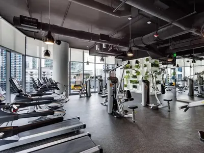 a gym with rows of treadmills and machines at Gorgeous Upscale Condo in the Middle of Brickell in Miami