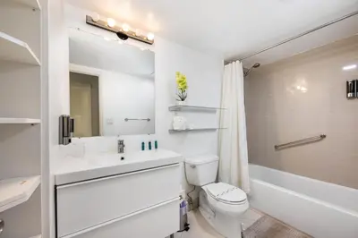 a white bathroom with a sink and a toilet at 2-Bedroom Beach Condo in Sunny Isles in Miami Beach