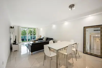 a living room with a table and a couch at 2-Bedroom Beach Condo in Sunny Isles in Miami Beach