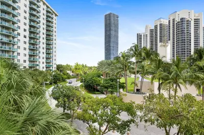 a view of a park with palm trees and buildings at 2-Bedroom Beach Condo in Sunny Isles in Miami Beach