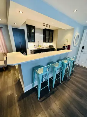 a kitchen with a blue counter and blue stools at Ft Lauderdale - Oasis in Fort Lauderdale