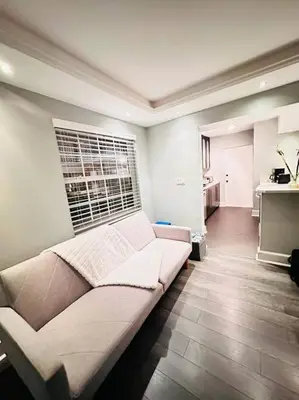 a living room with a couch and a window at Ft Lauderdale - Oasis in Fort Lauderdale