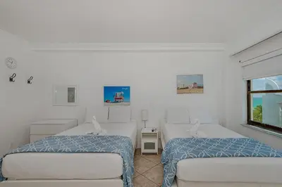 a bedroom with two beds and a window at Beach Front Studio Miami Beach in Miami Beach