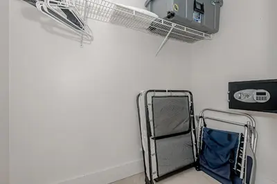 a luggage cart in a room with a wall at Beach Front Studio Miami Beach in Miami Beach