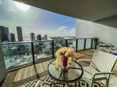 a balcony with a table and chairs and a view of the city at Lunabase Tropical Refuge in Miami