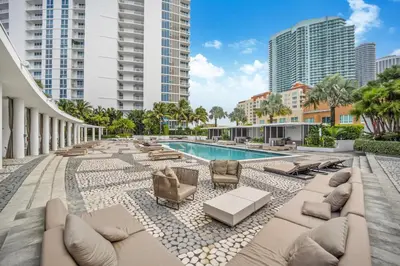 an outdoor swimming pool with chaise lounges and chairs at Lunabase Waterfront Paradise in Miami