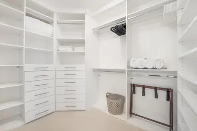 a white walk in closet with white cabinets at Lunabase Waterfront Paradise in Miami