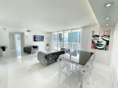 a living room with a table and a couch at Luxury Sky Villa with City and Ocean Views in Miami