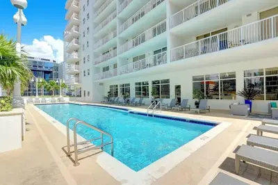 a swimming pool in front of a building at Luxury Sky Villa with City and Ocean Views in Miami