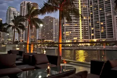 a restaurant with palm trees and a view of a city at Luxury Sky Villa with City and Ocean Views in Miami