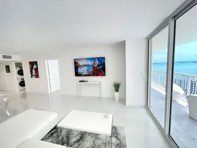 a white living room with a view of the ocean at Blissful Sky Residence with Ocean and City Views in Miami