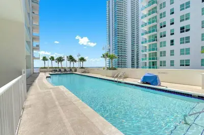 a swimming pool in a building with tall buildings at Blissful Sky Residence with Ocean and City Views in Miami