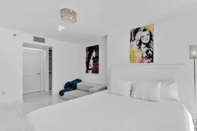 a white bedroom with a bed and a couch at Modern Sky Residence with Ocean and City Views in Miami