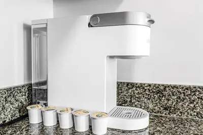 a row of cups on a counter under a sink at Majestic Penthouse with Ocean and City Views in Miami