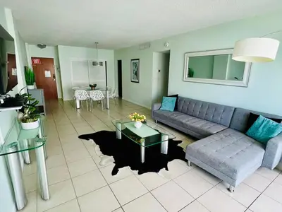 a living room with a couch and a table at Oceanview Beachfront Condo on Tides Resort in Hollywood