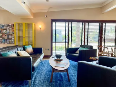 a living room with couches and a coffee table at Victoria Park Hotel in Fort Lauderdale