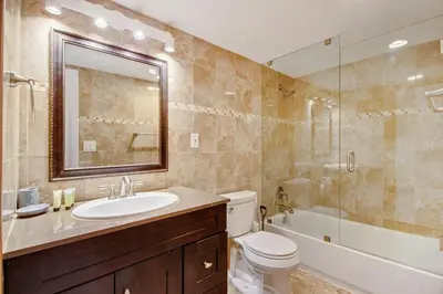 a bathroom with a sink and a toilet and a shower at Family Beach Home w Ocean & Bay Views - Upgraded Corner Unit in Miami Beach