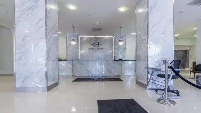 a lobby with a silver wall with a sign on it at Family Beach Home w Ocean & Bay Views - Upgraded Corner Unit in Miami Beach