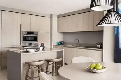 a kitchen with a table and a counter with chairs at Oceanview 2BR Suite At Hyde Beach House - 5☆ Amenities in Hollywood