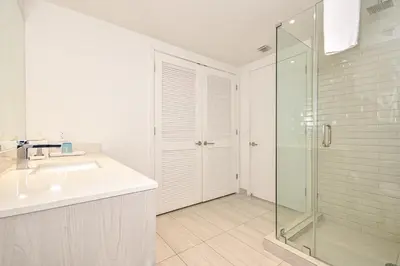 a bathroom with a sink and a glass shower at Oceanview 2BR Suite At Hyde Beach House - 5☆ Amenities in Hollywood