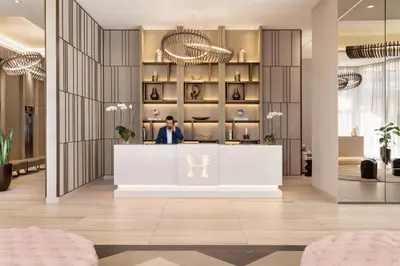 a man standing at a counter in a lobby at Oceanview 2BR Suite At Hyde Beach House - 5☆ Amenities in Hollywood
