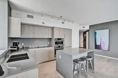 a kitchen with a counter and some stools in it at HYDE 2BR Panoramic Oceanview - No Resort Fees & Free Parking Exclusive to This Unit T3801 in Hollywood
