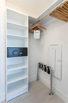 a walk in closet with white shelves and a door at HYDE 2BR Panoramic Oceanview - No Resort Fees & Free Parking Exclusive to This Unit T3801 in Hollywood