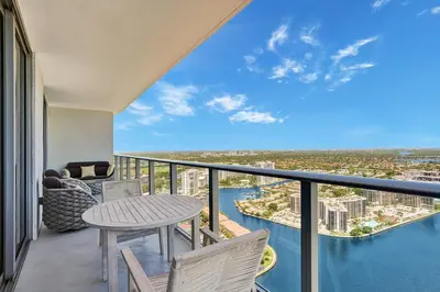 a balcony with a table and chairs and a view at HYDE 2BR Panoramic Oceanview - No Resort Fees & Free Parking Exclusive to This Unit T3801 in Hollywood