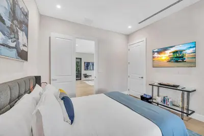 a bedroom with a large white bed in a room at Villa in Coral Gables with Pool Jacuzzi Game Room in Miami