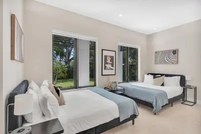 two beds in a room with two windows at Villa in Coral Gables with Pool Jacuzzi Game Room in Miami