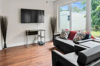 a living room with a couch and a tv at Stadium Sunflower Miramar home, 3 bd, 2 ba in Miramar