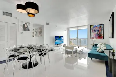 a living room with a table and a blue couch at 3BR Penthouse with European Flair n Amazing Views in Miami