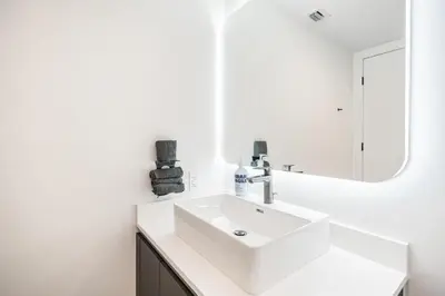 a white bathroom with a sink and a mirror at Explore Miami's Heat - Cozy Studio POOL & GYM in Miami