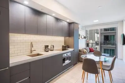 a kitchen with a table and a dining room at Explore Miami's Heat - Cozy Studio POOL & GYM in Miami