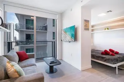 a living room with a couch and a table at Explore Miami's Heat - Cozy Studio POOL & GYM in Miami