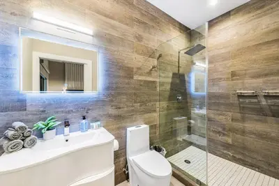 a bathroom with a toilet and a sink and a shower at Coconut Grove Villa with heated Pool sleeps 12 in Miami