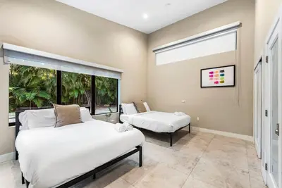 a bedroom with two beds and a window at Coconut Grove Villa with heated Pool sleeps 12 in Miami