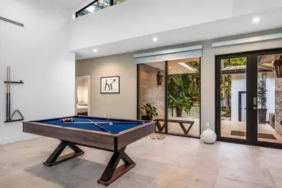 a living room with a pool table in it at Coconut Grove Villa with heated Pool sleeps 12 in Miami