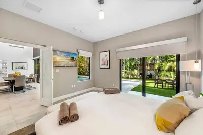 a large living room with a couch and a dining room at Coconut Grove Villa with heated Pool sleeps 12 in Miami