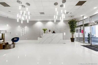 two people sitting at a counter in an office lobby at Luxurious private unit with parking in Miami